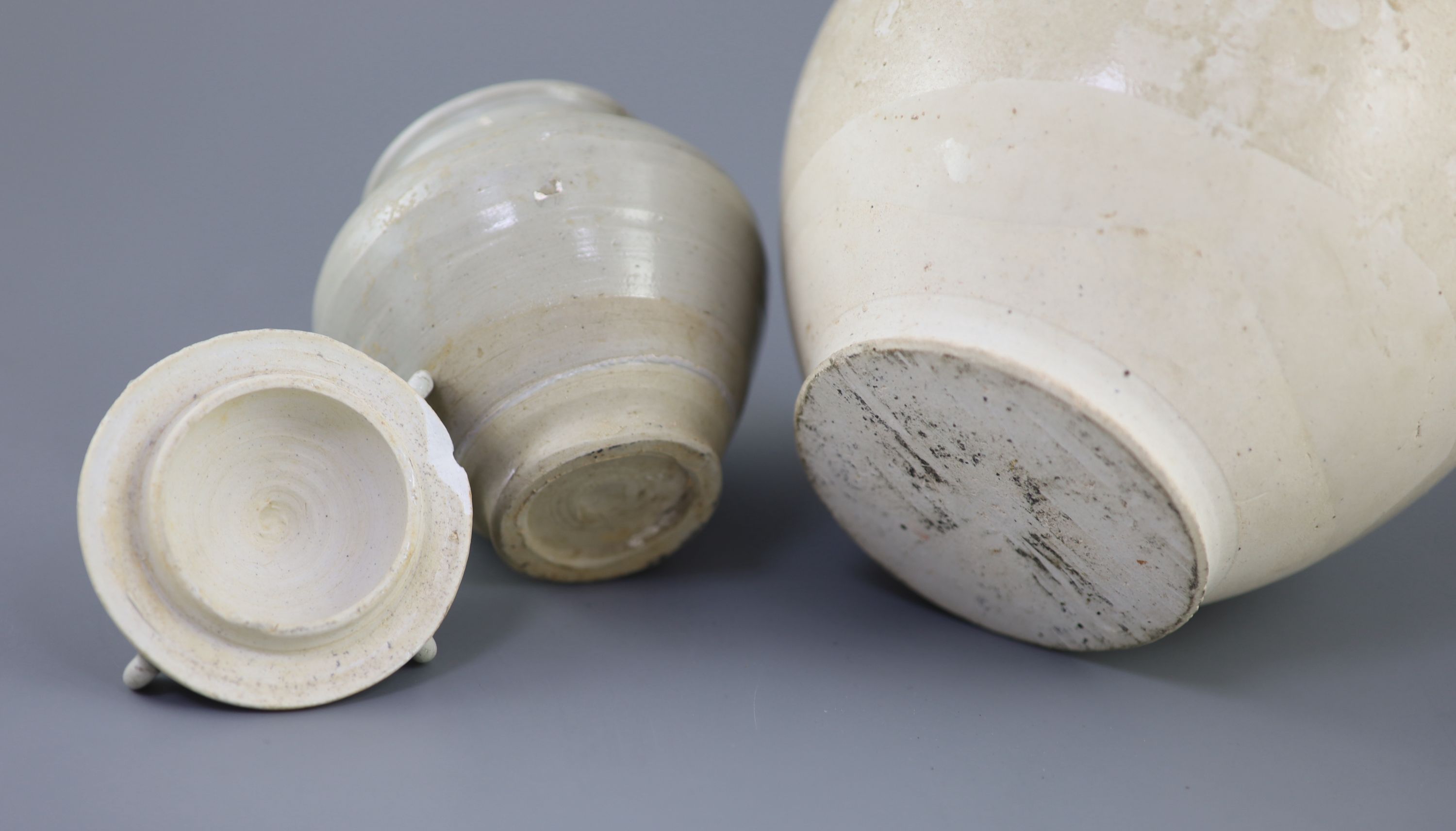 A Chinese cream glazed ovoid jar, Tang dynasty and a Ding type jar and cover, Yuan dynasty,